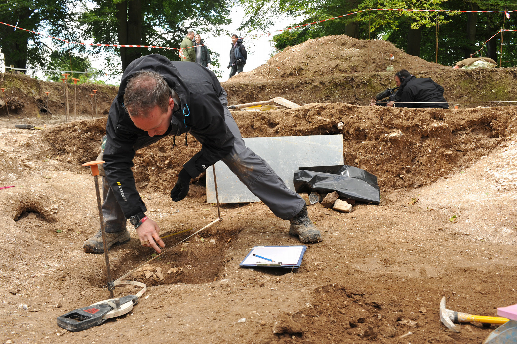 Personnel excavating an archeological dig site.